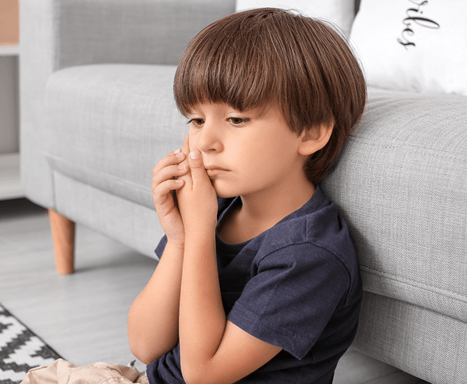 Little boy holding cheek in need of pulp treatment in Lake Saint Louis